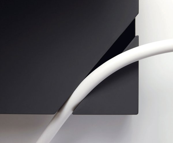 A perfectly spaced notch in the base of the lamp holds the cord in place, allowing the lamp's user to achieve a harmonious placement of fixture and flower.