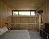 Modern home with Bedroom and Bed. Before he built the home, Cary climbed up ladders to ensure that each bedroom would be within earshot of the sound of the waves. Courtesy Architects and Artisans. Photo 9 of Shelter Island Retreat