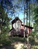 The opposite side of the bunkhouse, with the only enclosed bedroom, which leads to a small galley kitchen and two bathrooms, at right. This exit leads to a path to a nearby footbridge, swimming pool and outdoor bathhouse. Photo 3 of Texas Bunkhouse modern home