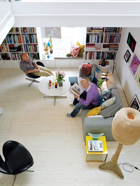 The living room has a close-up street view and abundant natural light. The sofa is Mags from Hay Studio, the table is an old Fritz Hansen base with a new top, and the Arne Jacobsen chair is also a refurbished vintage piece.