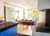 Modern home with Kitchen, Light Hardwood Floor, Colorful Cabinet, and Ceiling Lighting. Anne Cormier, principal of Atelier Big City, uses bold colors in her kitchen and dining area. Photo of Canada's Design Domestic