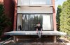 Martin Kohn, principal of Kohn Shnier Architects, sits atop the cantilevered porch of the Brookfield House. Photo of Canada's Design Domestic modern home