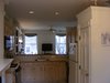 The existing kitchen had been remodeled in the mid-1980s and "had been pretty hastily done," Chris says. The cabinet joints had started to fail by the time the Greenawalts moved in but worst of all, the layout, with the unit's entrance leading immediately into the wall next to where the fridge was, "made a really small apartment feel tiny," Chris says. "We wanted to take that wall down and open it up." Photo of D House Kitchen Renovation modern home