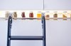 The element that makes the kitchen pop is the built-in spice row. "Typically every design I do is white so it's nice to have something that adds color," Chris says. He admits, however, that it's more for show than everyday use; "we've only used six of those spices," he says. As for what came first, the spice jars or the opening, the size of the gap was determined by the heights of the standard Ikea cabinets used. "From there it was a trial-and-error hunt for jars that would be as big as possible to fill the space but still be able to tilt out." Photo by Kate McElwee. Photo of D House Kitchen Renovation modern home
