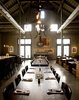 Modern home with Dining Room, Pendant Lighting, Stools, Concrete Floor, Chair, Track Lighting, Bench, Bar, Shelves, and Table. The location for the new restaurant, which opened in February 2010, was a barn on the ranch that had been used as a plant nursery. "It wasn't an incredibly old barn," Johanson says. "It was built around the 1970s, but it was built with a very agricultural look." To stay true to its form, Johanson and her colleagues Mark Wilson, Catharine Tarver, and Bridie McSweeney decided to leave as much of the structure intact as possible, playing up the post-and-beam system and revealing the shape of the roof on the interior. Photo of Farmstead Restaurant