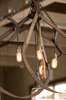 Less threatening found objects are the metal hay hooks that Johanson fashioned into light fixtures with the help of Lew Rosenberg at Electrics Architectural Lighting. "We found them up in Napa at a resale store that sells old junk," Johanson says. "We wanted to create the lights in a way that would be natural and would not just be 'prettying up the pig.'" Using entirely recycled and found parts (including the chains and the ropes), she strung the hooks together, along with Edison light bulbs, and hung the newly created pendants from the rafters. Photo of Farmstead Restaurant modern home
