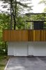 Modern home with Exterior, House, Flat RoofLine, Wood Siding Material, Glass Siding Material, and Metal Siding Material. “The first floor was about making something warm and woody that would blend into the natural environment,” architect Stephen Chung says of his Wayland, Massachusetts, home. “The second floor was a chance to experiment.” Photo of 16 Funky Facades