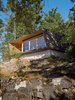 Modern home with Exterior, House Building Type, Cabin Building Type, Flat RoofLine, and Wood Siding Material. Perched over a cliff face, the hooded deck of the Gambier Residence reads like a ship’s prow over Howe Sound, the scenic waters near Vancouver. Photo of Modern Spaces in the Pacific Northwest
