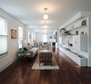 Modern home with Living Room, Sofa, Bookcase, Chair, Ceiling Lighting, and Dark Hardwood Floor. The living-dining room replete with a Wells sofa from Room and Board, occupies what was formerly a classroom. Photo of Take Two: 7 Adaptive Reuse Projects We Love