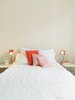 Modern home with Bedroom, Bed, and Table Lighting. The orange his-and-hers lamps in the bedroom came from Högner's sister's childhood bedroom. "My sister prefers new things," said Högner. "But my dad can't throw anything out. Photo of How to Design with Orange