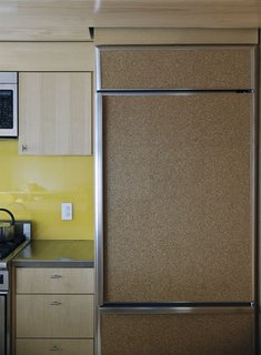 A fridge clad in cork provides a decidedly warm touch to the kitchen.