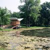 Modern home with Exterior, Cabin Building Type, Wood Siding Material, and Butterfly RoofLine. The hut, which was completed in 2010, measures in at just 97 square feet and sits along the north edge of a pond. Photo by Phillip Kalantzis-Cope. Photo of Butterfly Roof Meditation Hut
