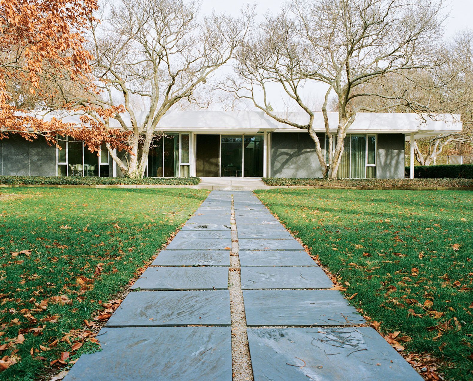 The pathway from the pool to the house is paved with the same slate that clads the exterior walls.