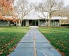 The pathway from the pool to the house is paved with the same slate that clads the exterior walls. Photo of Miller House in Columbus, Indiana by Eero Saarinen modern home