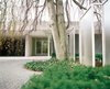 The front entrance of the Miller House is flanked by a series of glass screens, designed by either Dan Kiley or Girard. Photo 19 of Miller House in Columbus, Indiana by Eero Saarinen modern home
