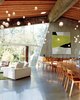 Modern home with Living Room, Sofa, Chair, Concrete Floor, Pendant Lighting, Bar, and Rug Floor. Arbel’s projects—both products and architectural commissions—follow a chronological numbering system. The house itself is his 23rd design, while the one-of-a-kind glass pendants that accent nearly every room like a starscape are called “28.” Photo 4 of 23.2 House