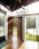 Modern home with Doors, Wood, Exterior, and Swing Door Type. While most homes have their front doors centered on a flat wall, this home in Canada by Omer Arbel is entered through two solid walnut doors at the corner of the home. Photo 8 of 23.2 House