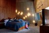Modern home with Bedroom, Bed, and Carpet Floor. Arbel’s “14” sconces spot the wall to ethereal effect in the master bedroom. “I wanted this place to be habitable. One of my greatest criticisms of modern architecture is that it often forgets to make things cozy.” Photo 14 of 23.2 House