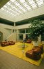 Once we move inside the Swink Agency to the lobby, we see that some very groovy action indeed. I love the telephone on the pedestal, the epic yellow rug, and the leather chairs by Tobia Scarpa for Cassina. They're Model 944 Soiranas from 1969. Also be sure to dig the overhang on that coffee table with the off-center base. Photo courtesy of Thom Abel. Photo of 40+ Yellow Modern Home Design Ideas modern home