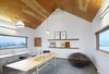 In addition to the barn-like roof, another key requirement for the house was a studio. In here, one of the couple creates collages and other works of art. Photo 7 of The Farm modern home