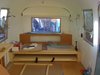 Brandes and Area 63 Productions designed this custom built-in platform sofa bed for the back of the Airstream. The lower platform pulls out and swings up on special hinges to turn the sofa into a queen size bed. Photo of Big Sur Airstream Renovation modern home