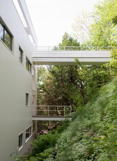 There are two walkways that extend over this sloping hillside. The top-most walkway is the intended entrance.