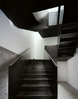 Making the most of a modest budget, the Hot Rod House relies on a single move—the insertion of a folded steel stair—to provide circulation while becoming a free-standing 3-D sculptural element. Large pivoting windows open the house to the outside. From a technical standpoint, the house serves as an on-going research project, e.g., the window frames double as the structural moment frame for the house, and the stair is constructed without stringers.