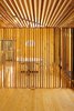 A seven-foot-tall entry screen made from raw heirloom cedar is a cozy decorative moment that first compresses one before launching him or her into the expansive shared space. Photo of Superior Logic modern home