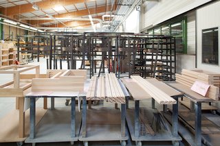 When an order comes in, workers feed the wood into a high-tech preprogrammed machine that mills it into ten square-sided posts and drills holes where the pieces will connect.