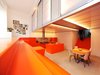 The kitchen and dining area and is surrounded by orange steps that function as seating. The dugout allows for a second level used for the bedrooms, which are housed in a polycarbonate "lightbox." Photo 2 of Parksite Residence, Rotterdam modern home