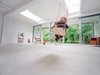 The living room is light and airy thanks to the glass wall and doors (formerly a solid wall) framing the parkland greenery outside. Photo 5 of Parksite Residence, Rotterdam modern home