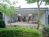 The whole rear of the home is open to the parkland setting, thanks to the glass wall and terrace. Photo 6 of Parksite Residence, Rotterdam modern home