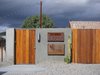 From the street, 67710 San Antonio Street in Desert Hot Springs, California, doesn't look all that exciting—though the streamlined wooden fence and jet-cut steel signage do give a hint of the modern style inside. Photo of 30+ Best Modern Fences modern home