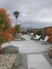 On the other side of the fence—built to protect the property from flash floods—is a desert oasis with cactus-lined walkways and patios set with butterfly chairs. Photo of A John Lautner-Designed Hotel modern home