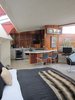 Modern home with Kitchen and Wood Cabinet. This is Unit 1, the most private of the four units. It's got a cool Milo Baughman sofa, a polished chrome coffee table by J. Wade Beam, a pair of Bertoia barstools, and a Thonet-inspired chair. Photo of A John Lautner-Designed Hotel
