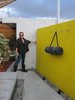The duo installed a small pool in a corner of the property, taking care not to disturb any of the existing architecture. As Beckmann demonstrates, they left space between the original building and the new day-glo yellow walls. Photo of A John Lautner-Designed Hotel modern home