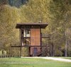 Modern home with Exterior, Cabin Building Type, Metal Siding Material, Flat RoofLine, House, Glass Siding Material, and Metal Roof Material. This 1,000 square-foot weekend cabin in Mazama, Washington, is essentially a "steel box on stilts," according to the firm. The three-story structure, which includes a living room and kitchen, can be completely shuttered when the owner is away. Photo of Olson Kundig Houses