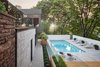 The architects sited the patio and swimming pool beneath a canopy of mature maple trees, an element that they say makes the site "an oasis in the heart of the city." Photo 2 of Prince-Philip Residence modern home