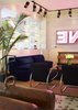 A comfortable seating area is situated a couple of steps into the hotel. The navy-blue sofa is ASH's design and the vintage armchairs with chrome handles are by Jindrich Halabala. Iron Origami fabricated the square coffee table just past the chairs. Artist Oliver Clegg created the neon sign. Photo 4 of The Dean Hotel in Providence modern home