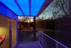 A balcony makes the most of the home's sloping site, offering views of the nearby forest and even faraway mountains. Photo of This Illuminated Arkansas Home Changes Colors with the Tap of a Smartphone modern home