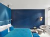 The artists used Old Navy paint from Benjamin Moore to give this guest room a blue hue. Photo 2 of The William - Bright Manhattan Hotel modern home