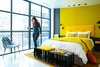 Neutral accents offset bright yellow details in this room. Photo 4 of The William - Bright Manhattan Hotel modern home