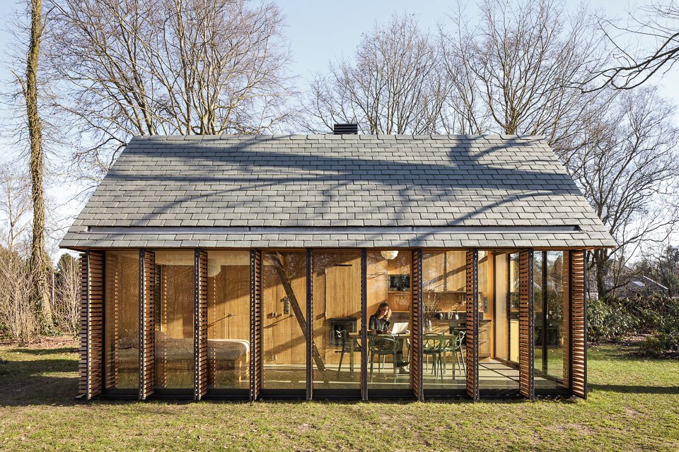 The west side is clad with six shutters made of horizontal, western red cedar slats that can be opened or closed with a single movement. "We wanted it to be able to feel cozy when needed," Oostenbruggen says.