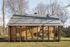 Modern home with Exterior, Shingles Roof Material, Cabin Building Type, and Wood Siding Material. The west side is clad with six shutters made of horizontal, western red cedar slats that can be opened or closed with a single movement. "We wanted it to be able to feel cozy when needed," Oostenbruggen says. Photo 4 of Utrecht Cabin