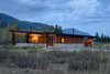 The house is divided in two: on the left, the main house consists of an expansive kitchen, living, and dining space, plus sleeping accommodations. On the right, a smaller structure holds a sauna, shower, and ski wax room. The house’s length is oriented along an east/west axis to maximize strong southern light and provide views of an aspen grove. Photo of Modern Mountain Retreat in Washington modern home