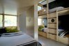 Adjacent to the main living room are four custom bunk beds and a guest bedroom with a queen bed. Photo of Modern Mountain Retreat in Washington modern home