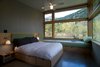 Lastly, a master bedroom opens up to the landscape around it and can sleep an extra two guests on day beds. Photo of Modern Mountain Retreat in Washington modern home