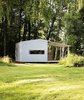 Modern home with Exterior, House Building Type, Wood Siding Material, Gable RoofLine, and Prefab Building Type. The homes are painted wood, and include a shaded deck space, plus full insulation and electricity, for a price of about $29,000. Photo of Tiny Prefabricated House Can Be Built in Two Days