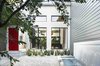 Modern home with Outdoor, Small Pools, Tubs, Shower, Concrete Pools, Tubs, Shower, and Front Yard. A deep-red door adds a pop of color to the ipe-enclosed front courtyard of this in Winter Park, Florida. Maintaining an indoor/outdoor connection was important to the family, as was a simple and sustainable material palette that includes wood and polished concrete. Photo of Water Features We Love modern home