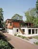 Modern home with Exterior, Concrete Siding Material, Metal Siding Material, Shipping Container Building Type, House Building Type, and Prefab Building Type. Purchasing a lot off the Delaware River in Pennsylvania, Martha Moseley and Bill Mathesius adapted an unused concrete foundation—remnants of its previous owner’s abandoned plans—to create a home that’s uniquely their own. “We were inspired by the site, and our desire to have something cool and different,” says Moseley. Photo of 20 Ideas On What You Can Do With Old Shipping Containers